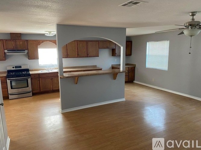 A kitchen with wooden cabinets and a stove top oven.