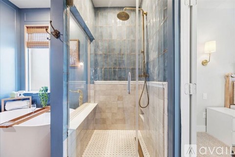 A modern bathroom with a walk-in shower and a bathtub.