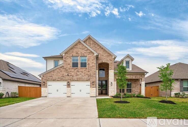 A large house with a driveway in front.