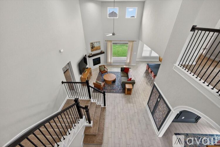 A living room with a staircase leading to the upper floor.