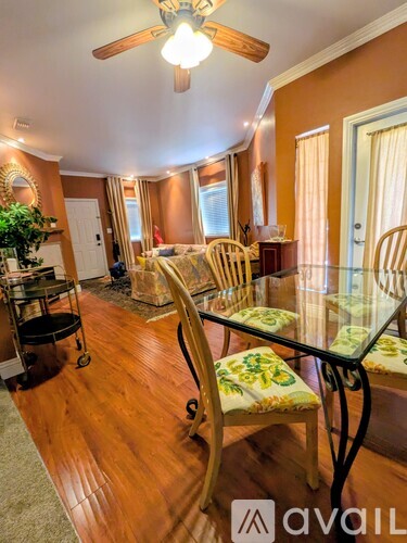 A dining room with a glass table and chairs.