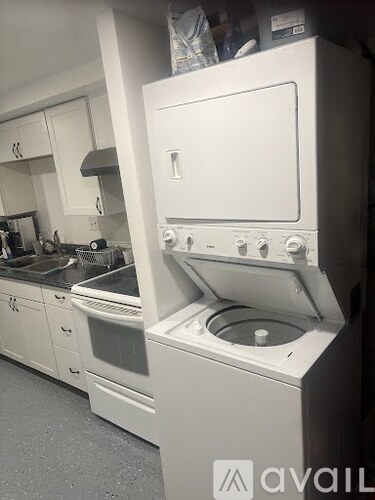 A white oven with a stove top sits in a kitchen.