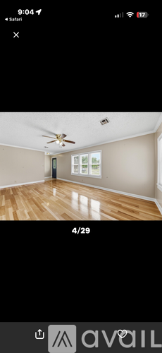 A room with wooden flooring and a ceiling fan.