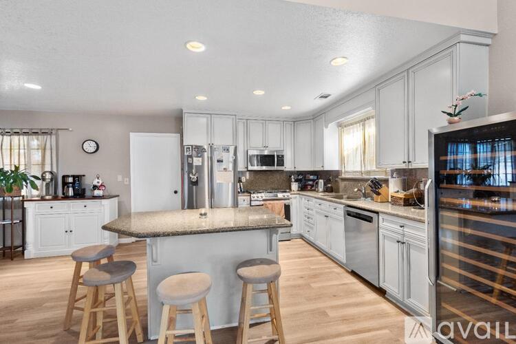 A kitchen with a bar area and stools.