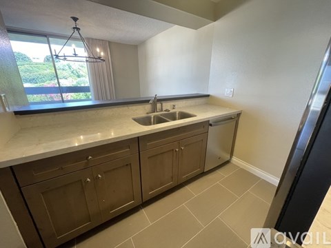 A kitchen with brown cabinets and a white countertop.