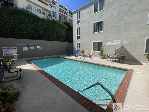 A small pool with a red border and a metal ladder.