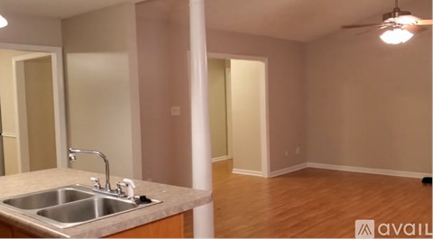A kitchen with a sink and a mirror.