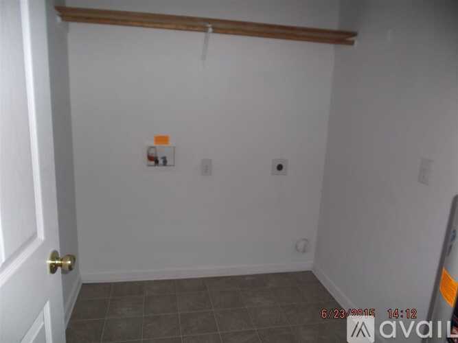 A small room with a door on the left and a wall on the right.