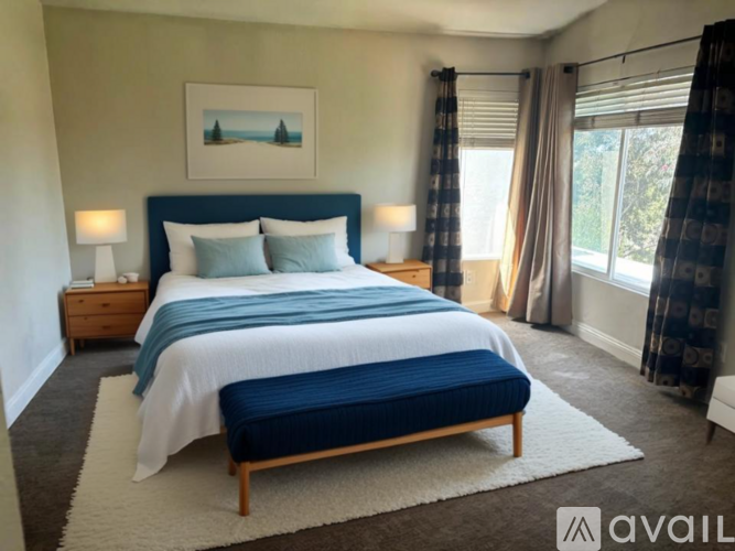 A bedroom with a large bed and a painting above it.