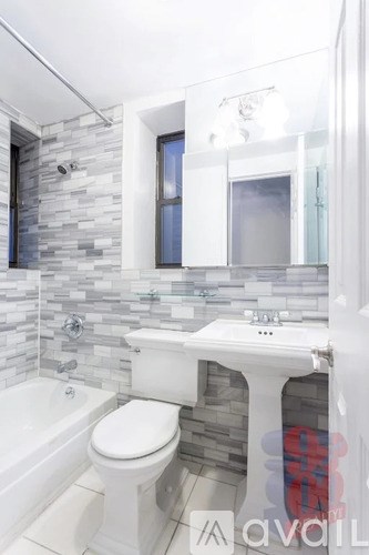 A bathroom with a white toilet and sink.