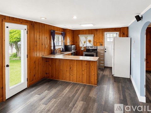 A kitchen with wooden cabinets and a white refrigerator.