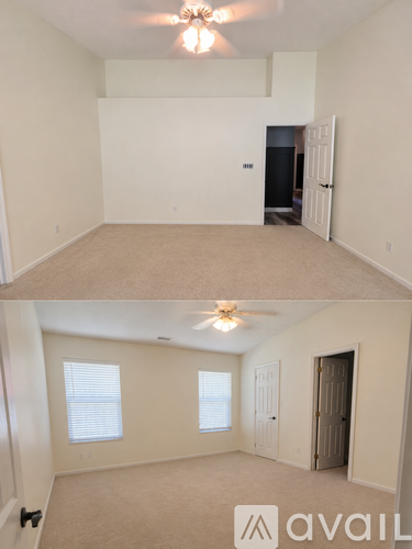 A room with a ceiling fan and carpeted floor.