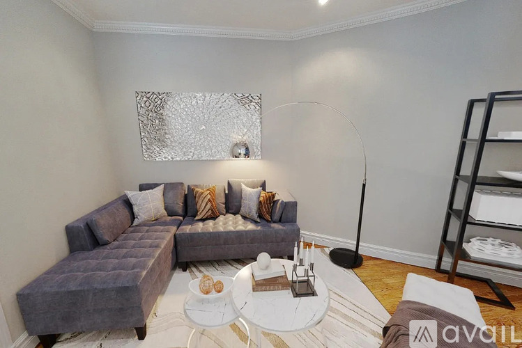 A living room with a grey sofa and a white coffee table.