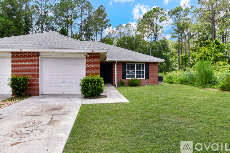 A house with a garage and a driveway in front of it.