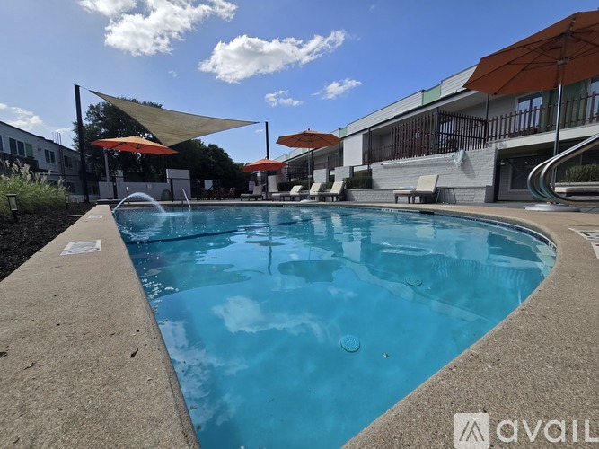 A swimming pool with a blue water and a white edge.
