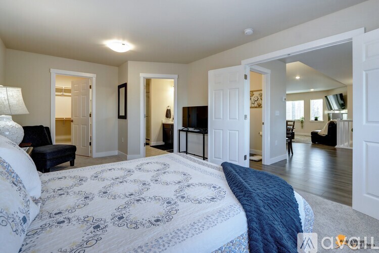 A bedroom with a large bed and a blue blanket.