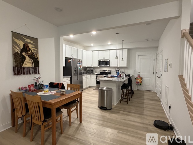 A modern kitchen with a dining table set for four.