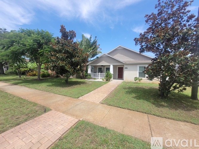 A house with a driveway and trees in front.