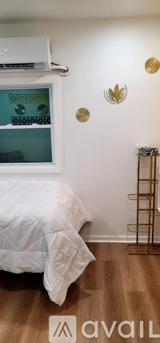 A bedroom with a bed and a wall decoration.