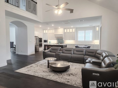 A modern living room with a large sectional sofa and a coffee table.