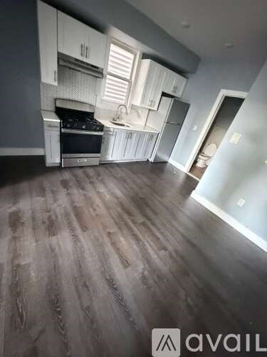 A kitchen with white cabinets and a black stove top oven.