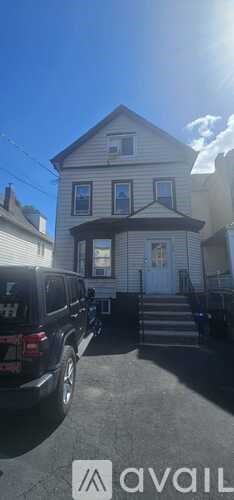 A house with a car parked in front of it.
