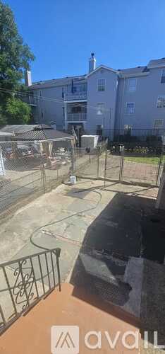 A playground with a basketball court and a slide.