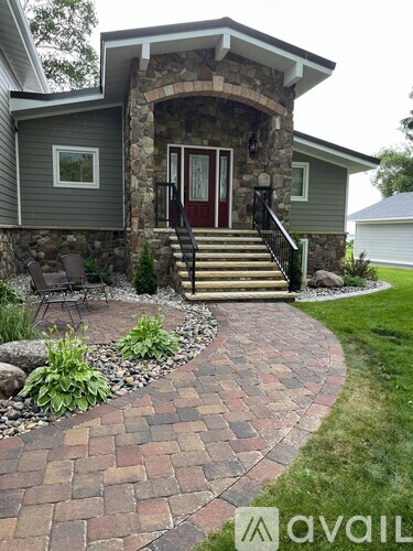 A house with a red door and a stone pillar.