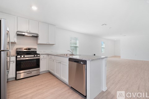 A kitchen with white cabinets and stainless steel appliances.