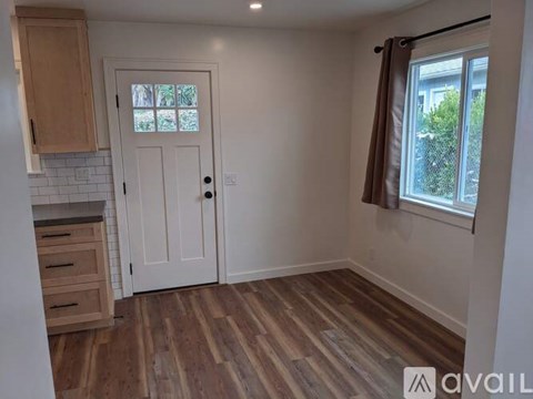 A room with wooden floors and a white door.