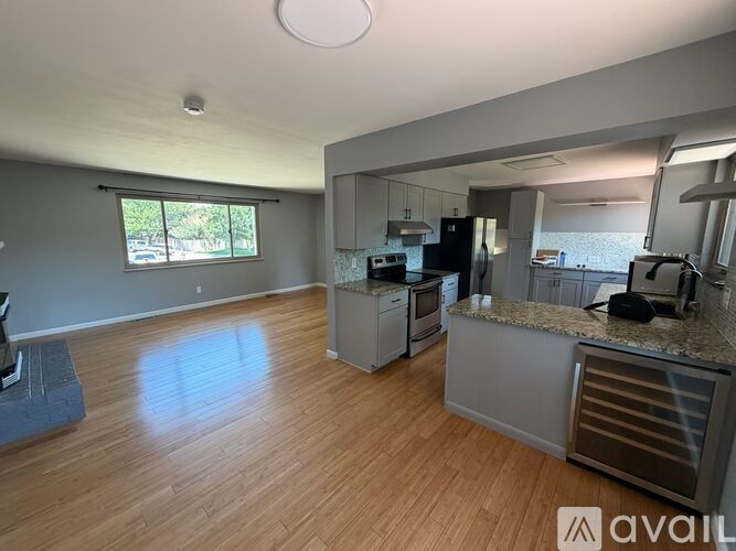A kitchen with wooden floors and a large island.