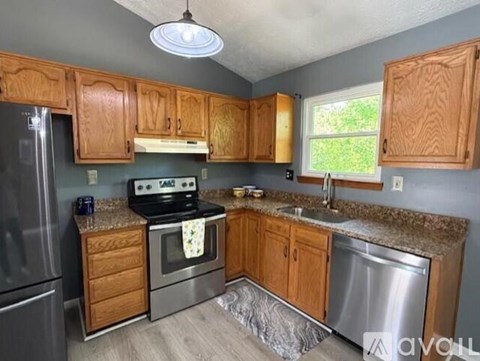 A kitchen with wooden cabinets and stainless steel appliances.