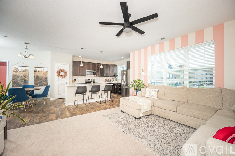 A living room with a beige couch and a white coffee table.