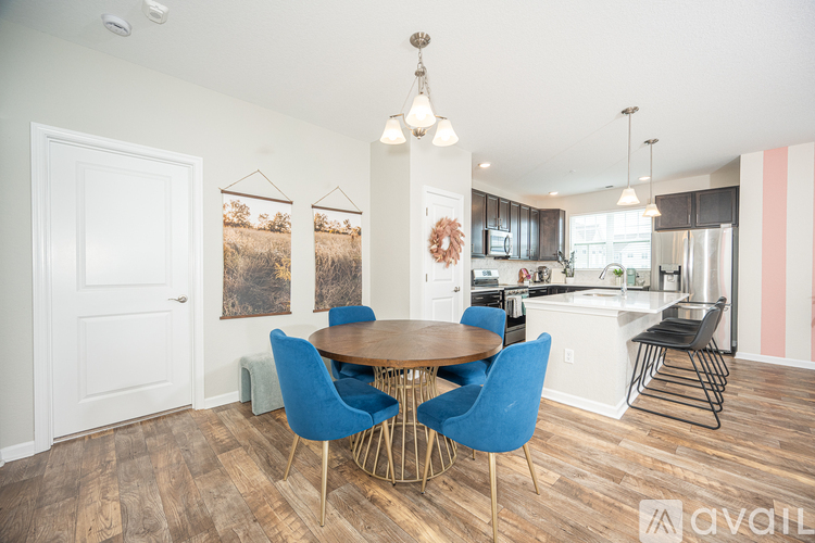 A dining room with a wooden table and blue chairs.