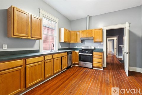 A kitchen with wooden cabinets and a stove top oven.