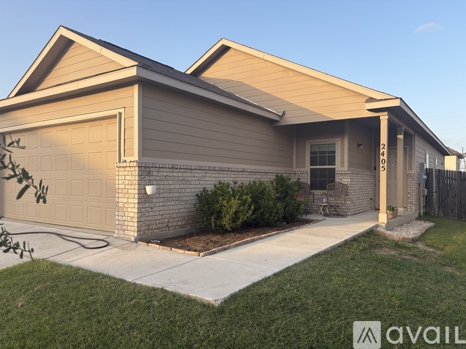 A house with a garage and a driveway in front.
