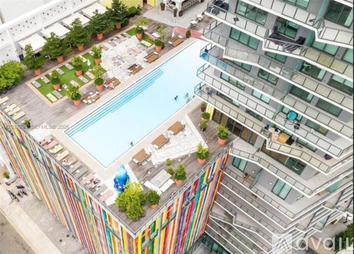 A multi-story building with a pool in the middle.
