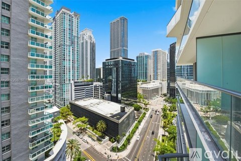 A cityscape with tall buildings and a clear sky.