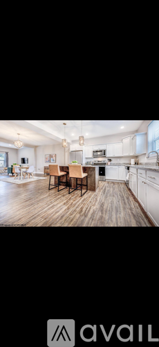 A kitchen with a dining table and chairs in the middle of the room.