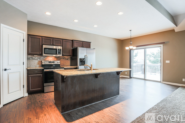A kitchen with a black island in the middle of the room.