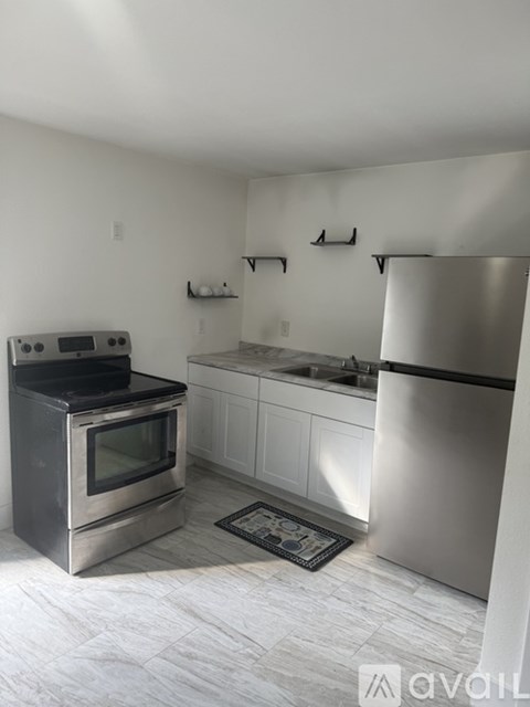 A kitchen with a stainless steel refrigerator and an oven.