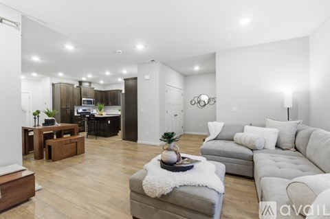 A modern living room with a grey sofa and a wooden coffee table.