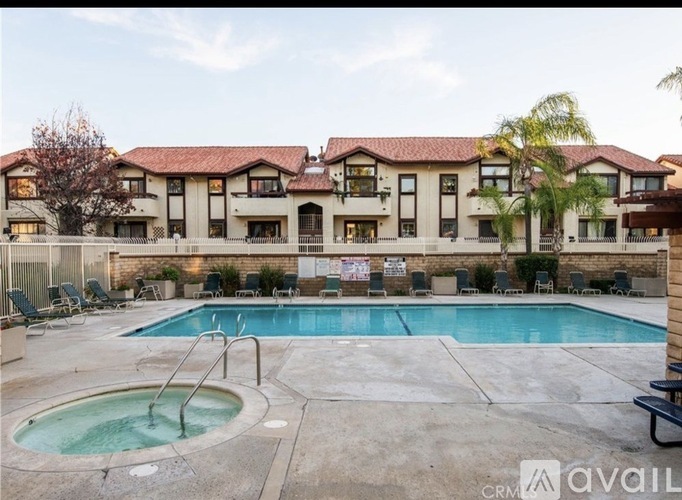 A large house with a pool in front.