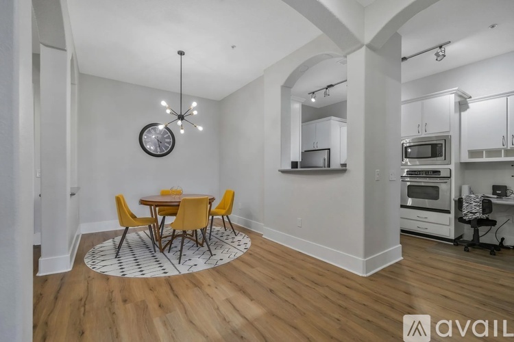 A kitchen with a dining table and chairs in the middle of the room.