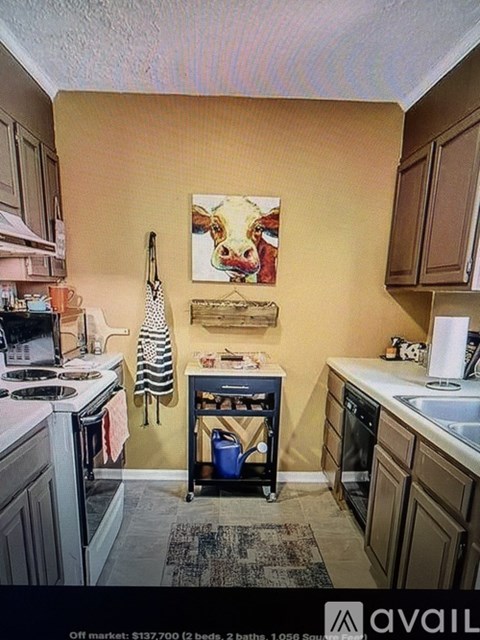 A kitchen with a painting of a woman on the wall.