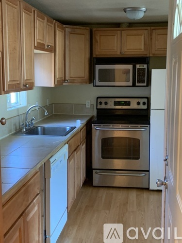 A kitchen with wooden cabinets and stainless steel appliances.