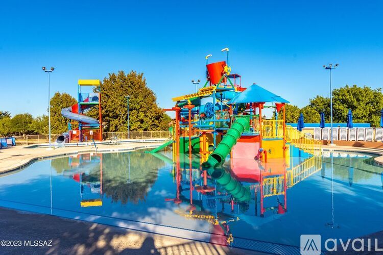 A colorful water playground with slides and a pool in the foreground.