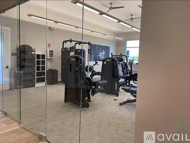A gym with a variety of equipment including a treadmill, weights, and a bench press.