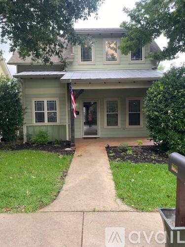 A house with a flag on the front porch.