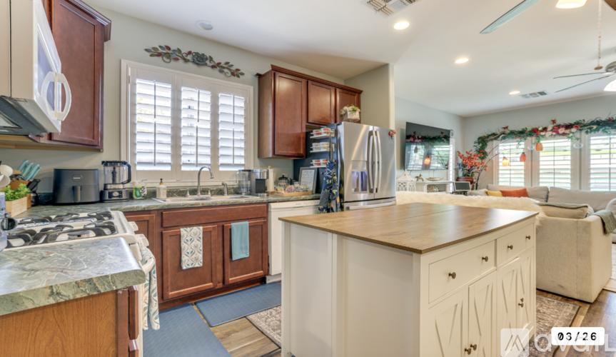 A kitchen with brown cabinets and a white island.